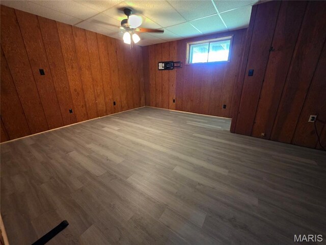 18835 Mary Jane Ln, Carlyle, IL 62231 - empty room with a ceiling fan, wood finished floors, and wooden walls