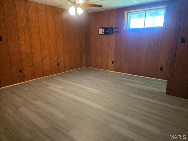 18835 Mary Jane Ln, Carlyle, IL 62231 - spare room featuring a ceiling fan, wood finished floors, and wood walls