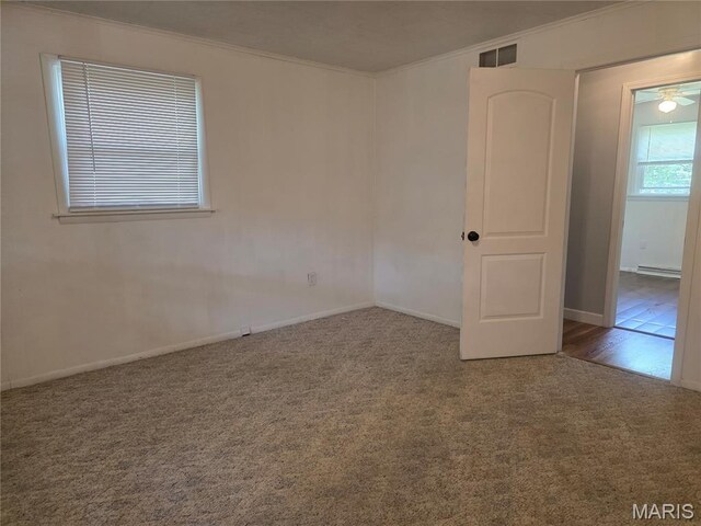18835 Mary Jane Ln, Carlyle, IL 62231 - carpeted empty room with ornamental molding, a baseboard radiator, and baseboards