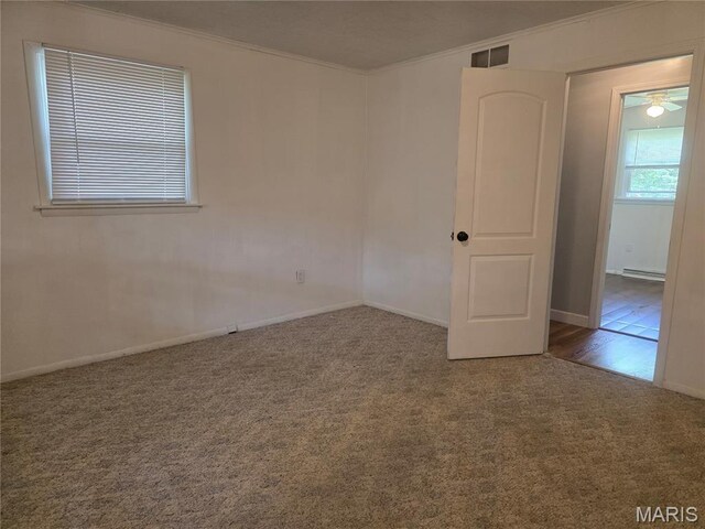 18835 Mary Jane Ln, Carlyle, IL 62231 - spare room with ornamental molding, carpet, a baseboard heating unit, baseboards, and ceiling fan