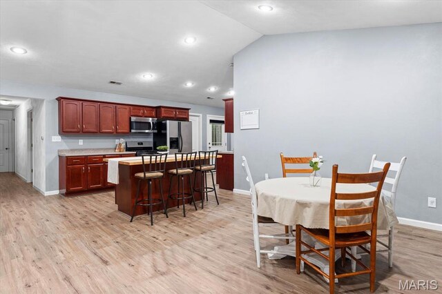 9138 Lynwood Ln, Fairview Heights, IL 62208 - dining room with baseboards, light wood-type flooring, lofted ceiling, and recessed lighting