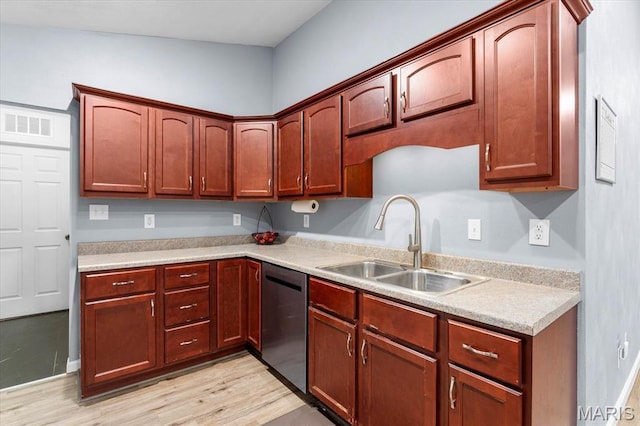 9138 Lynwood Ln, Fairview Heights, IL 62208 - kitchen with dishwasher, a sink, light countertops, and light wood-style flooring