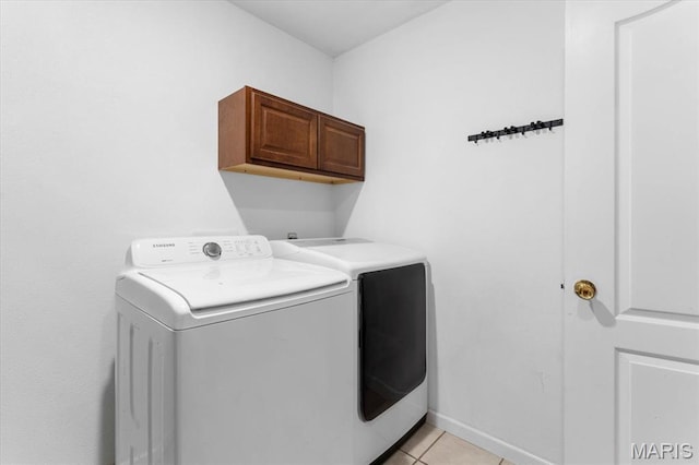9138 Lynwood Ln, Fairview Heights, IL 62208 - washroom with separate washer and dryer, cabinet space, and light tile patterned flooring