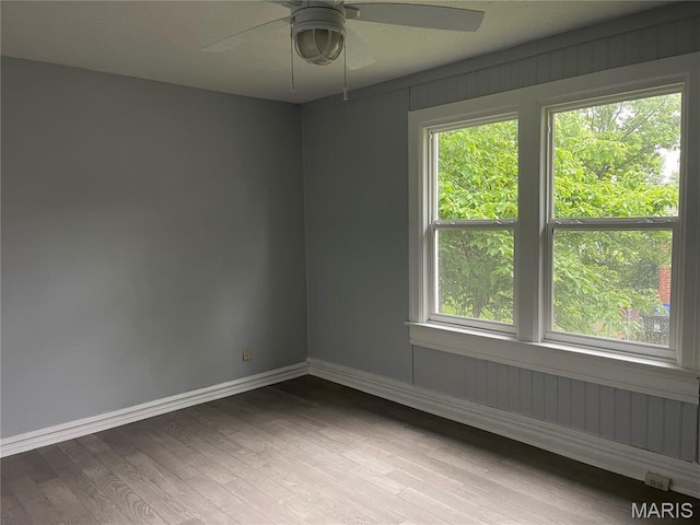 1432 Tamerton Ave, Overland, MO 63132 - empty room featuring a ceiling fan, wood finished floors, and plenty of natural light