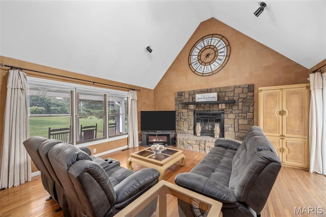 795 Schluersburg Rd, Augusta, MO 63332 - living room with high vaulted ceiling, a fireplace, and light wood-style flooring