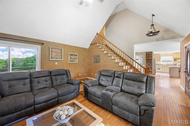 795 Schluersburg Rd, Augusta, MO 63332 - living room with stairway, high vaulted ceiling, light wood finished floors, a ceiling fan, and baseboards