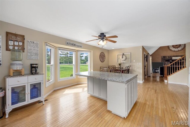 795 Schluersburg Rd, Augusta, MO 63332 - kitchen featuring light wood-style floors, a ceiling fan, baseboards, and white cabinets