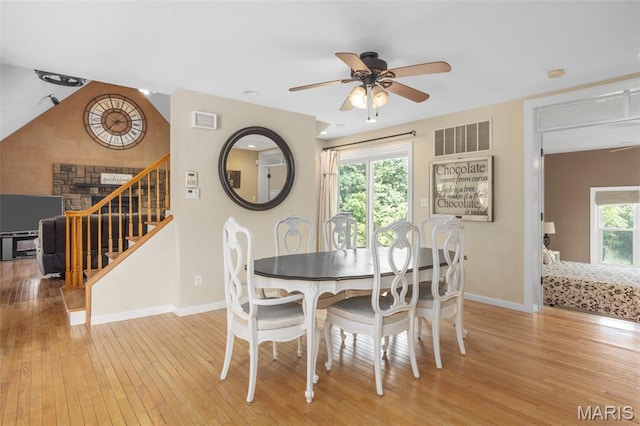 795 Schluersburg Rd, Augusta, MO 63332 - dining room featuring wood-type flooring, ceiling fan, baseboards, and stairway
