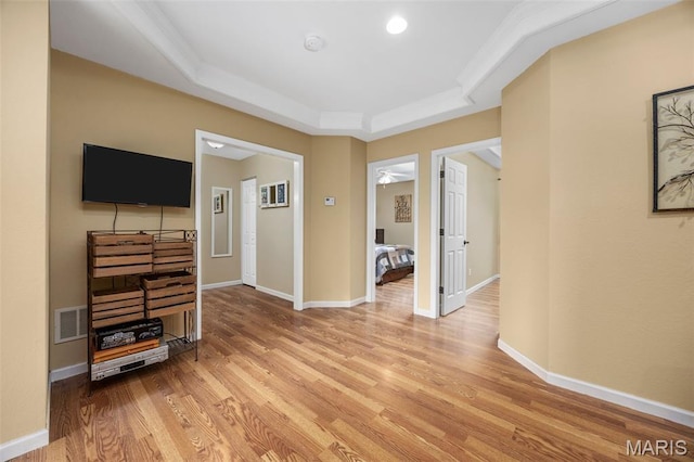 795 Schluersburg Rd, Augusta, MO 63332 - unfurnished living room with a raised ceiling, light wood-style flooring, and baseboards