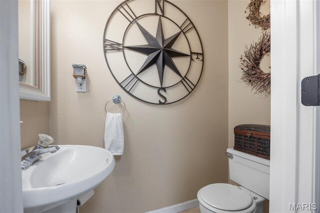 795 Schluersburg Rd, Augusta, MO 63332 - half bathroom with toilet, a sink, and baseboards