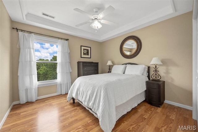 795 Schluersburg Rd, Augusta, MO 63332 - bedroom featuring a raised ceiling, baseboards, and light wood-type flooring