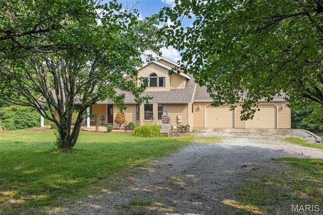 795 Schluersburg Rd, Augusta, MO 63332 - obstructed view of property with driveway, a front lawn, a garage, and roof with shingles