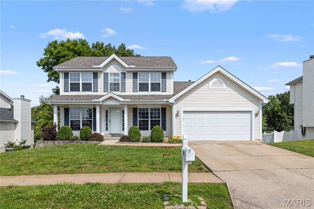 1141 Hickory Ridge Trl, Arnold, MO 63010 - traditional-style home featuring an attached garage, driveway, and a shingled roof