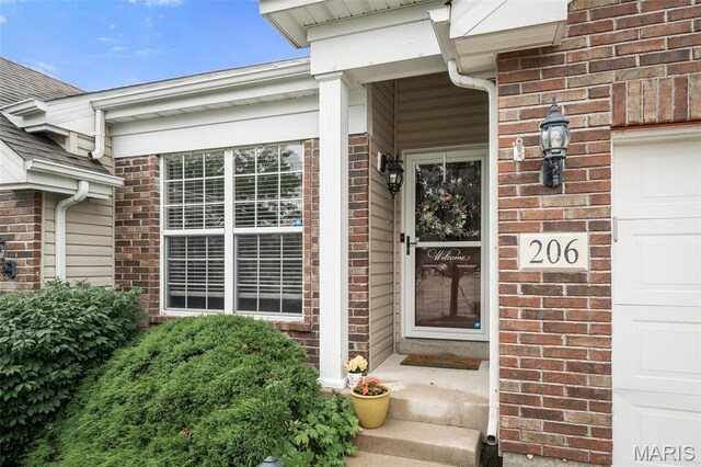 206 Belmonte Cir, Ofallon, MO 63368 - doorway to property with brick siding and an attached garage