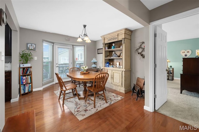 206 Belmonte Cir, Ofallon, MO 63368 - dining space featuring a chandelier, light wood-style flooring, and baseboards