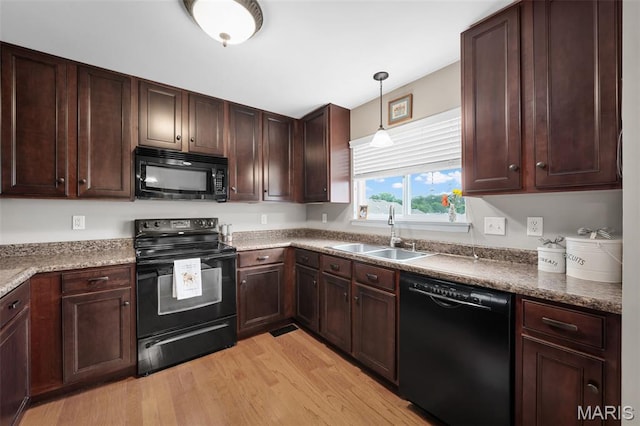 206 Belmonte Cir, Ofallon, MO 63368 - kitchen featuring black appliances, a sink, light wood finished floors, and dark brown cabinets