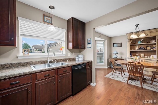 206 Belmonte Cir, Ofallon, MO 63368 - kitchen featuring black dishwasher, a sink, light wood finished floors, decorative light fixtures, and dark countertops