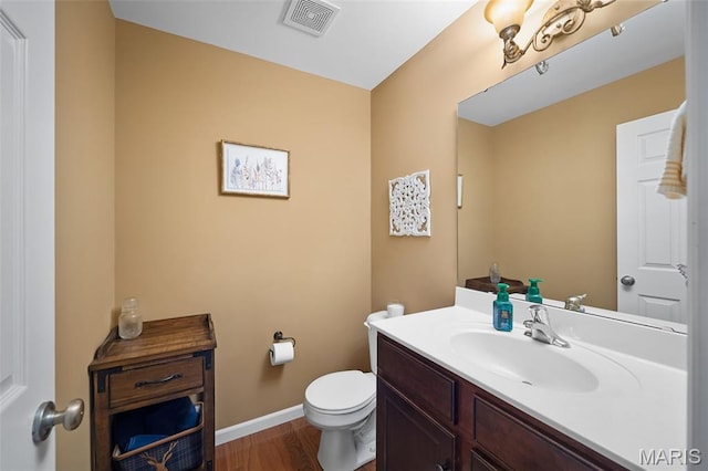 206 Belmonte Cir, Ofallon, MO 63368 - bathroom featuring toilet, vanity, baseboards, and wood finished floors