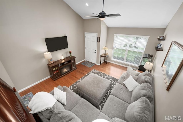 206 Belmonte Cir, Ofallon, MO 63368 - living area with lofted ceiling, ceiling fan, wood finished floors, and baseboards