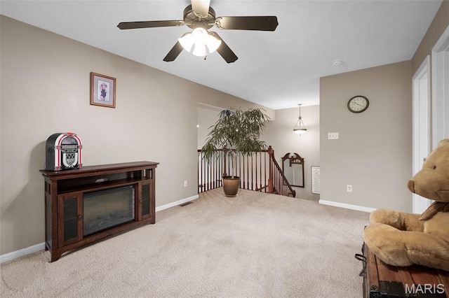 206 Belmonte Cir, Ofallon, MO 63368 - sitting room with an upstairs landing, carpet flooring, a ceiling fan, and baseboards