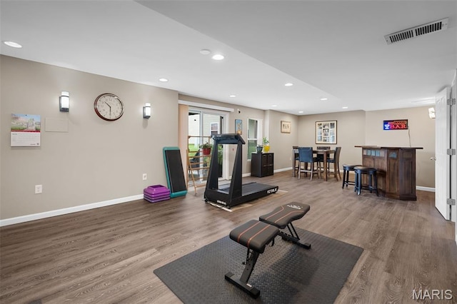 206 Belmonte Cir, Ofallon, MO 63368 - exercise room with a dry bar, wood finished floors, baseboards, and recessed lighting
