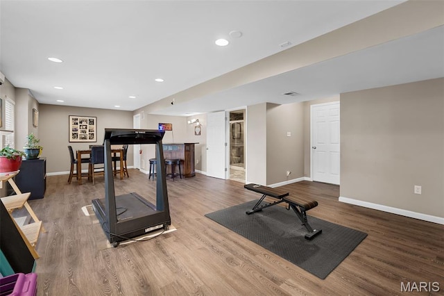 206 Belmonte Cir, Ofallon, MO 63368 - exercise room with a bar, baseboards, wood finished floors, and recessed lighting