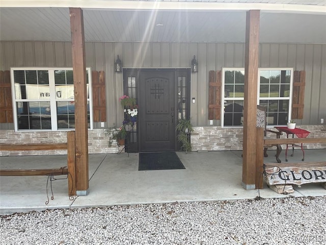10570 Old 8 E, Mineral Point, MO 63660 - entrance to property featuring stone siding, covered porch, and board and batten siding