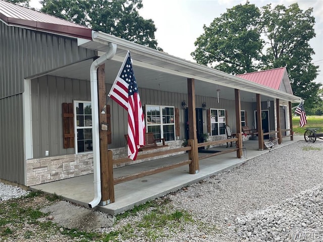 10570 Old 8 E, Mineral Point, MO 63660 - property entrance featuring covered porch, metal roof, and stone siding