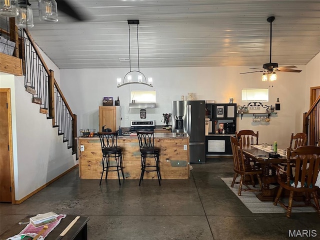 10570 Old 8 E, Mineral Point, MO 63660 - kitchen featuring appliances with stainless steel finishes, finished concrete floors, a center island, and a ceiling fan