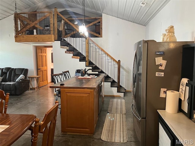10570 Old 8 E, Mineral Point, MO 63660 - dining room featuring concrete flooring, high vaulted ceiling, and stairs