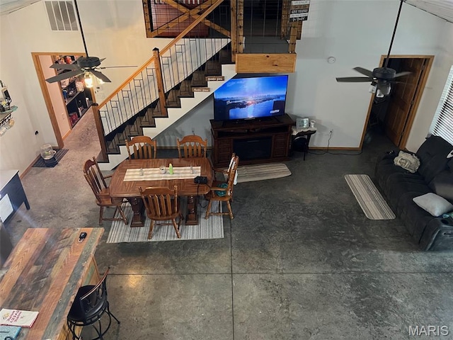 10570 Old 8 E, Mineral Point, MO 63660 - dining area featuring a ceiling fan, stairs, concrete flooring, and baseboards