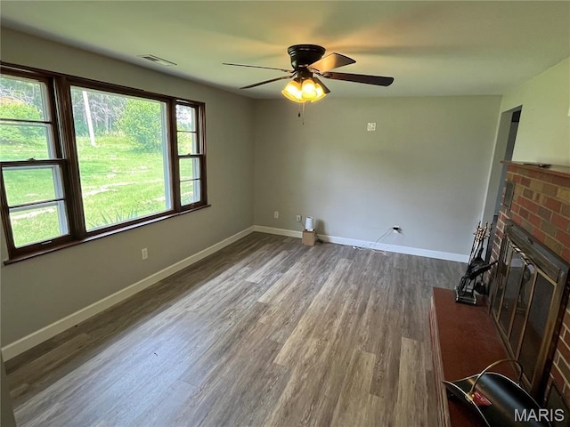 42 Davis Rd, Troy, MO 63379 - unfurnished living room with a ceiling fan, dark wood-style floors, and a brick fireplace