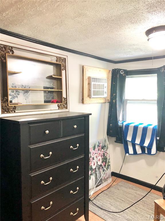 1003 W Ellis St, Salem, MO 65560 - bathroom with a textured ceiling, vanity, and a wall unit AC