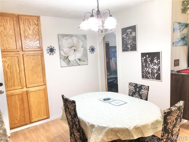 1003 W Ellis St, Salem, MO 65560 - dining space with a chandelier and light wood-style flooring