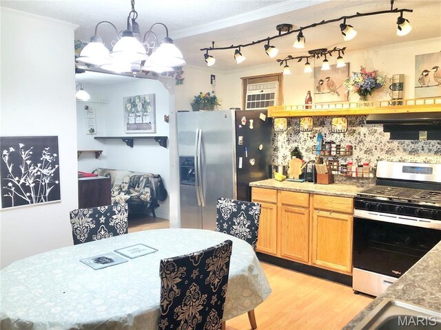 1003 W Ellis St, Salem, MO 65560 - kitchen featuring stainless steel appliances, crown molding, a chandelier, under cabinet range hood, and light wood-style floors