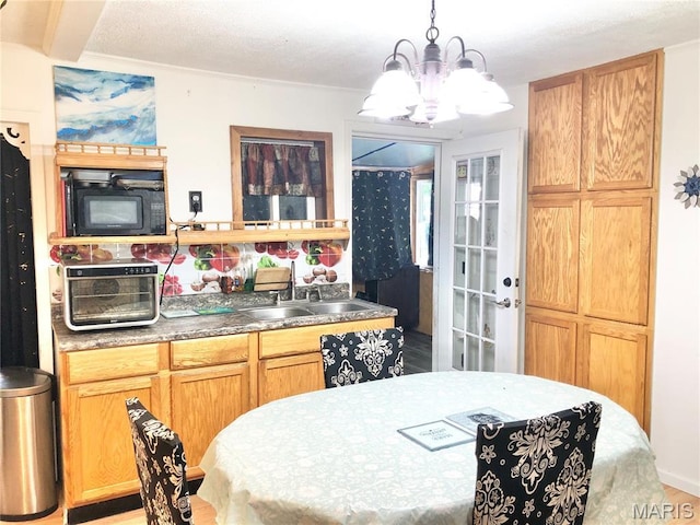 1003 W Ellis St, Salem, MO 65560 - kitchen with a sink, black microwave, a chandelier, and decorative light fixtures
