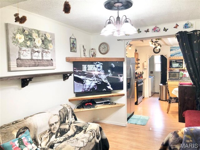 1003 W Ellis St, Salem, MO 65560 - living area with a chandelier, a textured ceiling, ornamental molding, and wood finished floors