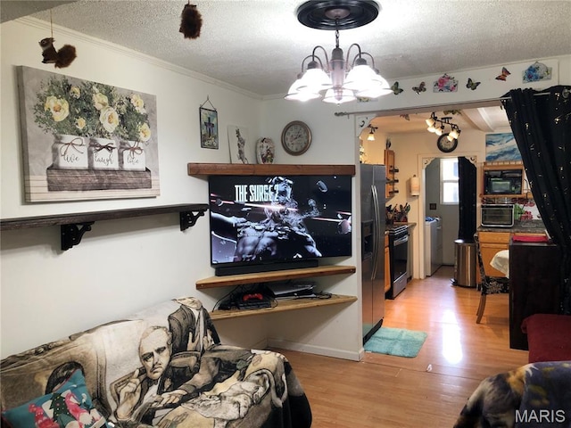 1003 W Ellis St, Salem, MO 65560 - living room featuring a chandelier, a textured ceiling, light wood-type flooring, crown molding, and washer / clothes dryer