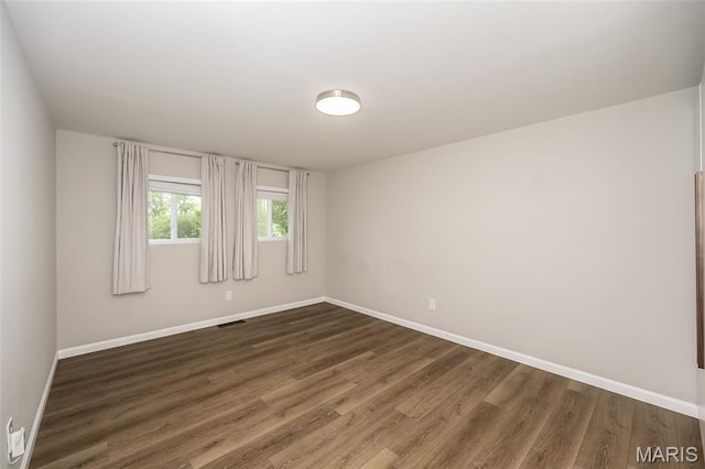 3271 Alfred Ave, Saint Louis, MO 63116 - spare room featuring baseboards and dark wood-type flooring