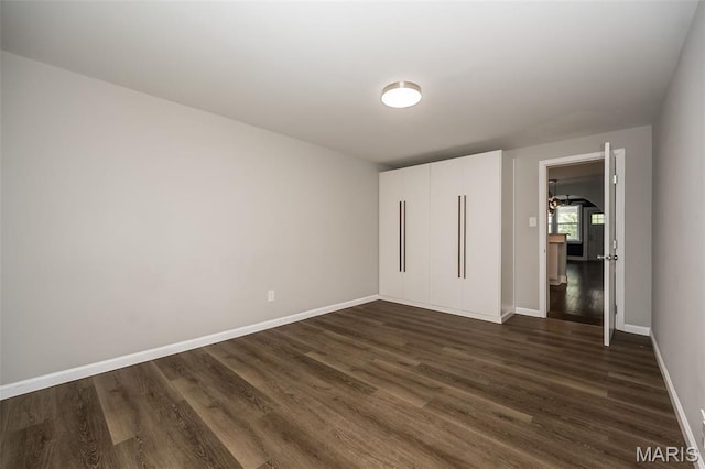 3271 Alfred Ave, Saint Louis, MO 63116 - unfurnished bedroom with dark wood finished floors and baseboards
