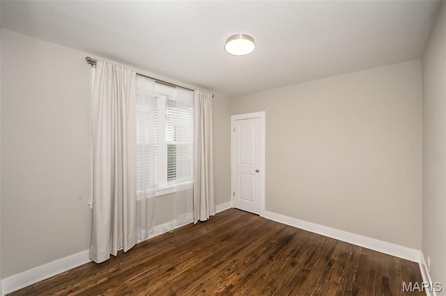 3271 Alfred Ave, Saint Louis, MO 63116 - spare room featuring baseboards and dark wood-style flooring