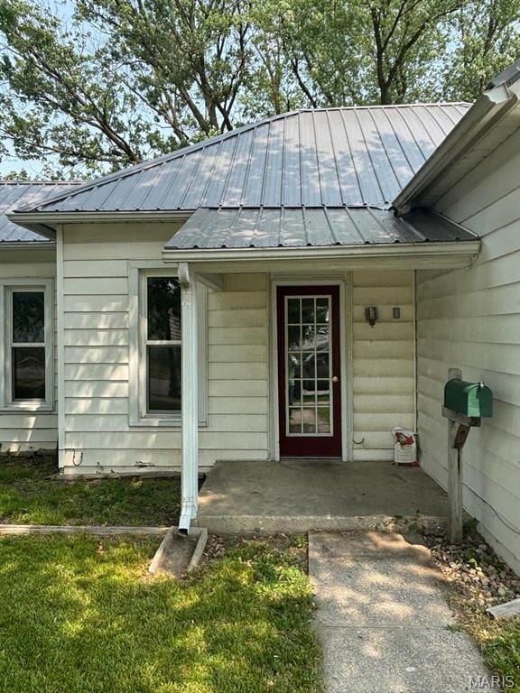 410 S Main St, Monroe City, MO 63456 - doorway to property with a metal roof and a lawn