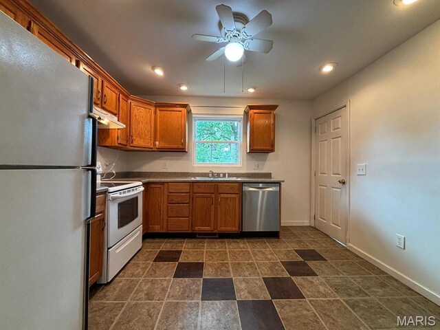 410 S Main St, Monroe City, MO 63456 - kitchen with white appliances, under cabinet range hood, ceiling fan, brown cabinetry, and recessed lighting