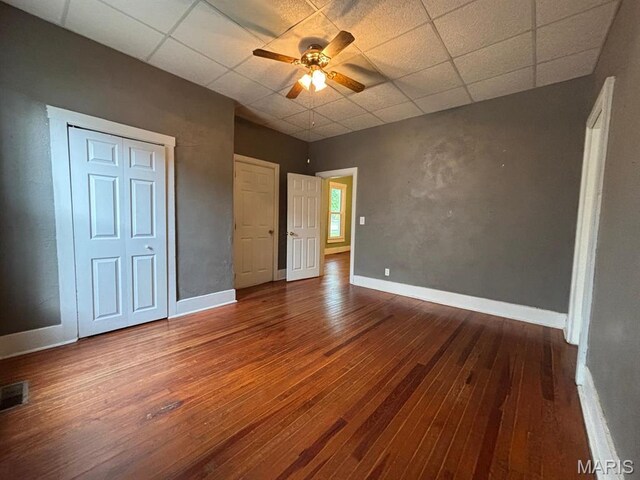 410 S Main St, Monroe City, MO 63456 - unfurnished bedroom featuring a paneled ceiling, wood-type flooring, and a ceiling fan