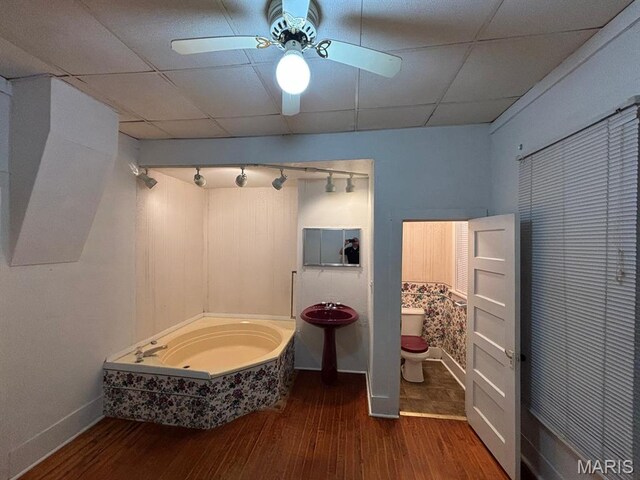 410 S Main St, Monroe City, MO 63456 - full bathroom featuring wood finished floors, ceiling fan, and a paneled ceiling