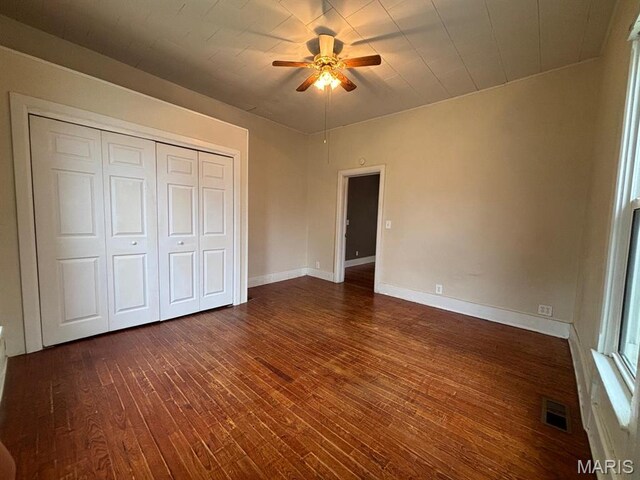 410 S Main St, Monroe City, MO 63456 - unfurnished bedroom featuring dark wood-style floors, a closet, and a ceiling fan