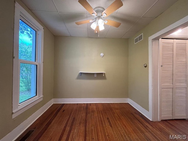 410 S Main St, Monroe City, MO 63456 - empty room featuring hardwood / wood-style flooring, plenty of natural light, and a ceiling fan