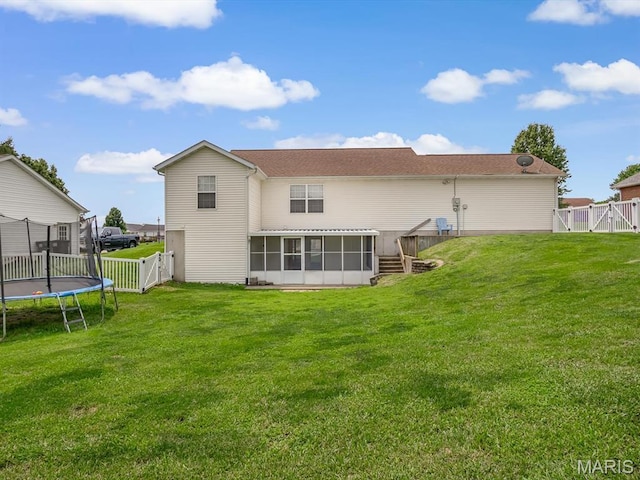 109 E Red Bud Ct, Valmeyer, IL 62295 - back of house with a gate, a sunroom, a trampoline, and a fenced backyard