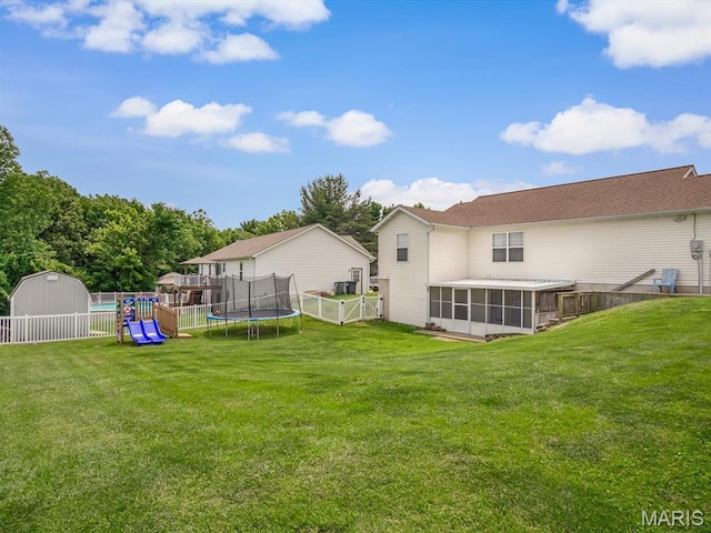 109 E Red Bud Ct, Valmeyer, IL 62295 - fenced backyard with a sunroom, a trampoline, a shed, and a playground