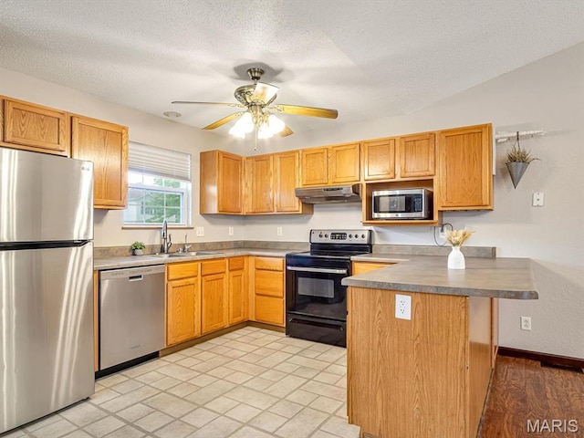 109 E Red Bud Ct, Valmeyer, IL 62295 - kitchen with appliances with stainless steel finishes, under cabinet range hood, ceiling fan, a textured ceiling, and a peninsula
